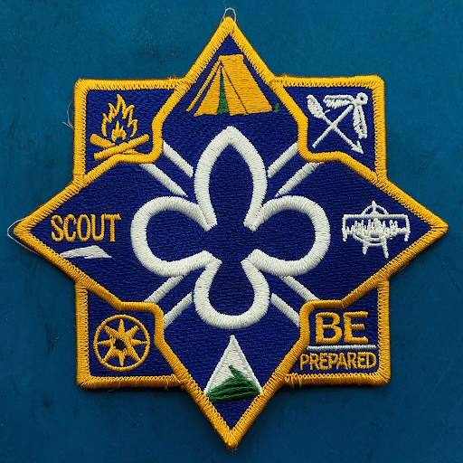a custom scout patch with a blue background and a white trefoil emblem a custom scout patch with a blue background and a white trefoil emblem